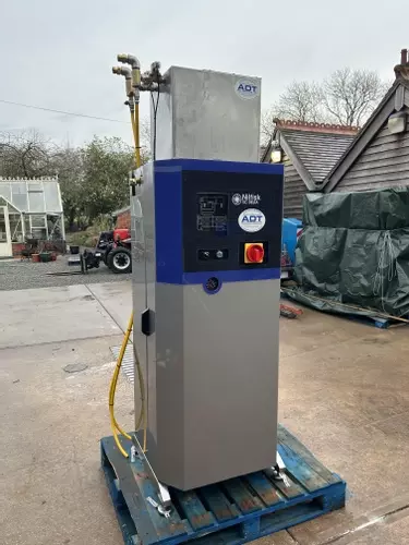 Reconditioned Delta booster pressure washer positioned outside on a pallet prior to installation at a factory in Measham.